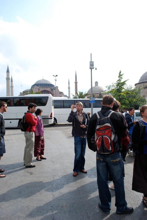 Alex A. makes a memory amongst the tour buses in the square in front of Ayia Sofia.