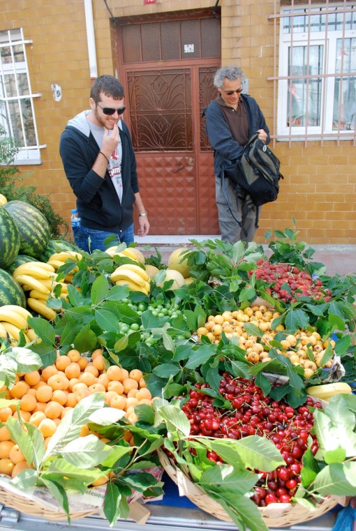 Chris and Prof. Christesen investigate a fruit vendor's cart.